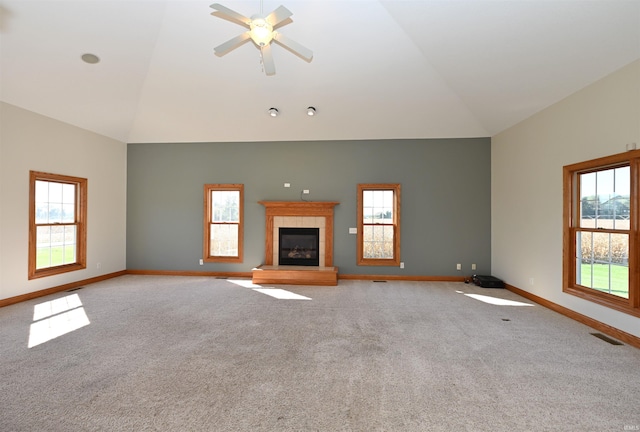 unfurnished living room featuring a wealth of natural light, ceiling fan, and light colored carpet