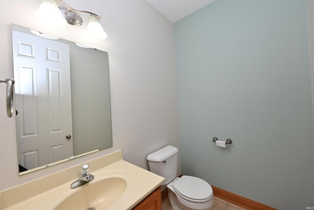 bathroom featuring vanity, toilet, and tile patterned floors