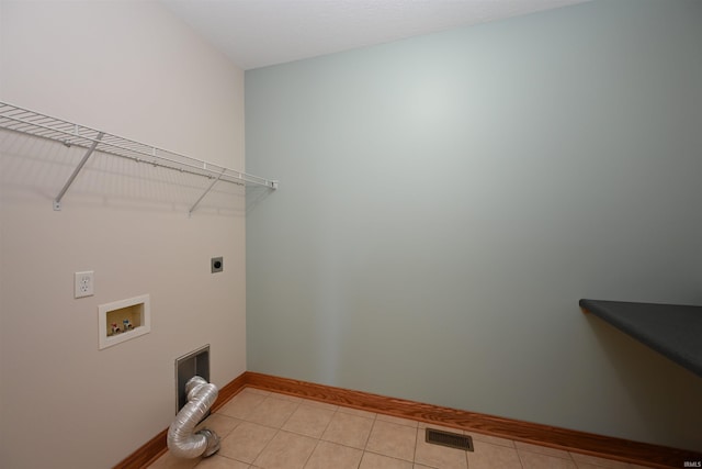 laundry area featuring hookup for a washing machine, light tile patterned floors, and electric dryer hookup