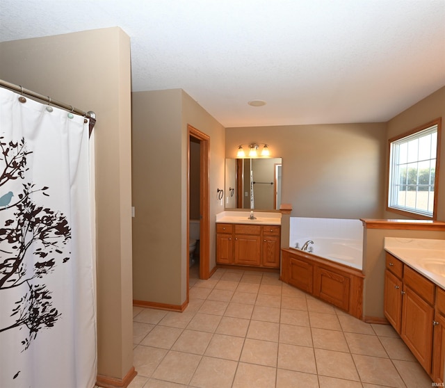 bathroom featuring vanity, toilet, a bath, and tile patterned floors