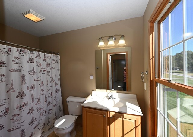 bathroom featuring a shower with curtain, vanity, and toilet