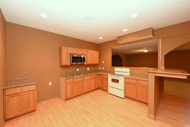 kitchen with light hardwood / wood-style floors, white electric range, sink, and light brown cabinets