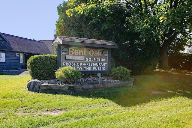 community / neighborhood sign with a yard