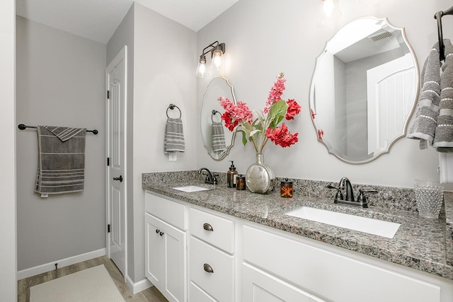 bathroom featuring vanity and hardwood / wood-style flooring