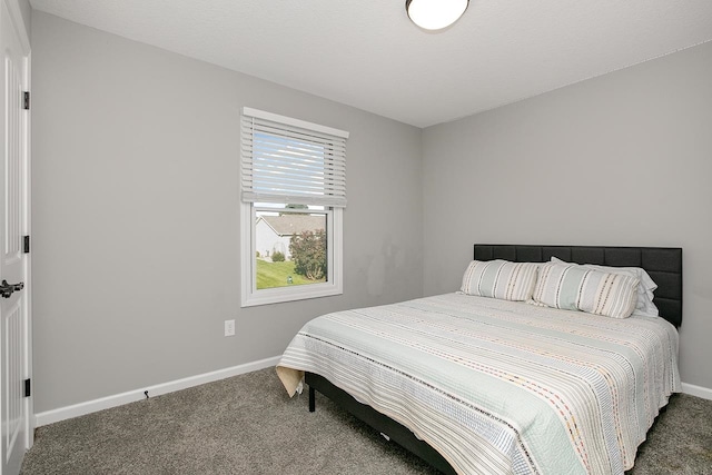 bedroom featuring dark carpet