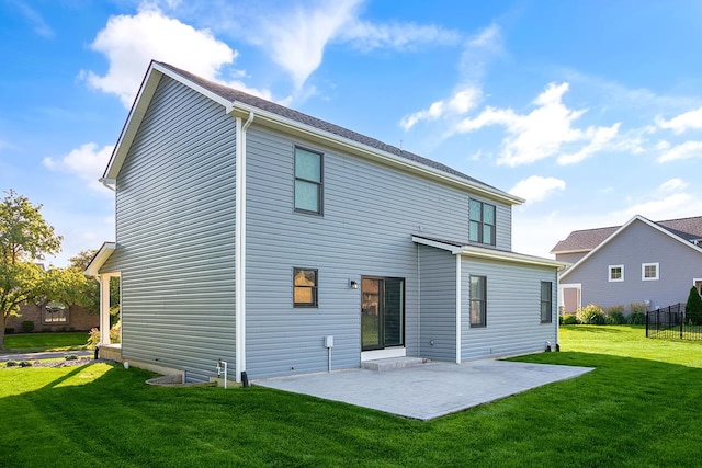 rear view of property featuring a patio and a yard