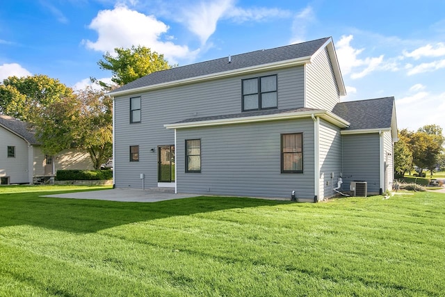 back of property featuring a patio, central AC, and a yard