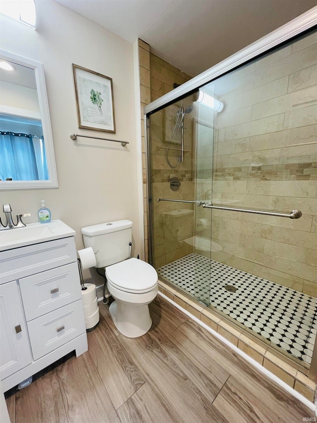 bathroom featuring walk in shower, vanity, and toilet