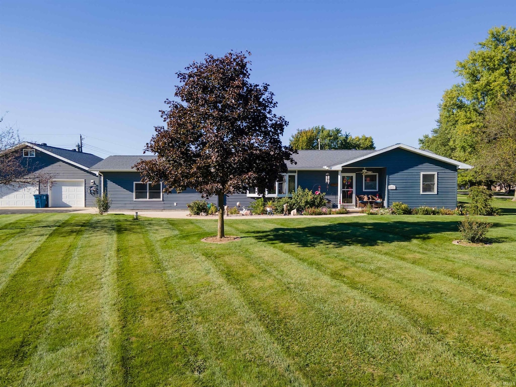 view of front of property with a garage and a front lawn