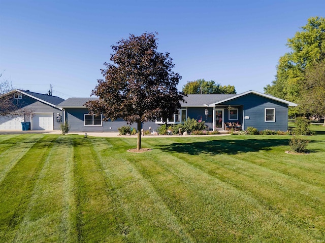 view of front of property with a garage and a front lawn