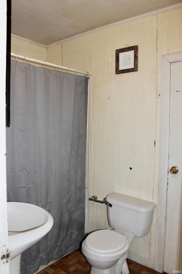 bathroom featuring walk in shower, toilet, and parquet flooring