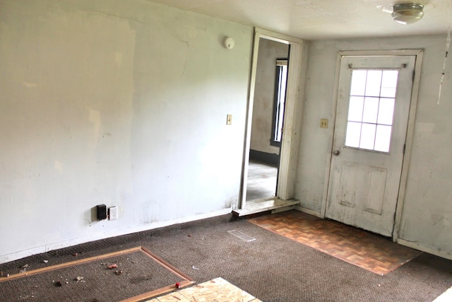 doorway with dark parquet flooring