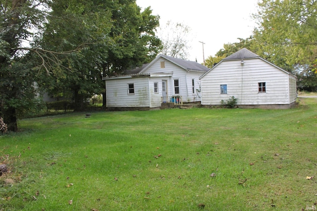 rear view of property with a lawn