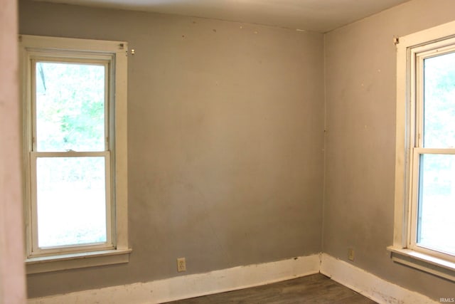 empty room featuring dark hardwood / wood-style floors and a wealth of natural light