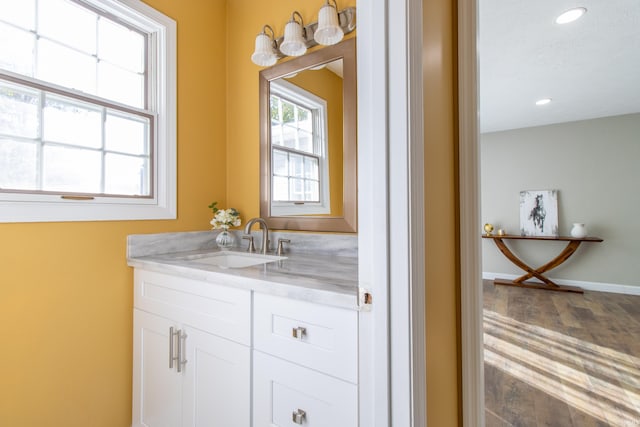 bathroom with vanity and hardwood / wood-style floors