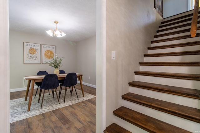 dining space with an inviting chandelier and dark wood-type flooring