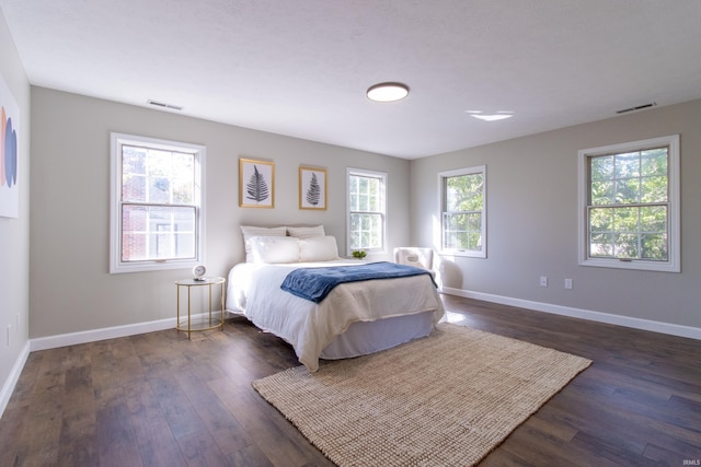 bedroom with dark wood-type flooring