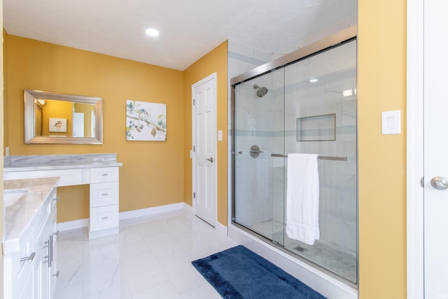 bathroom featuring vanity and a shower with shower door