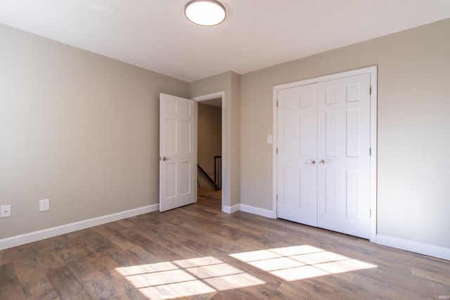 unfurnished bedroom with a closet and light hardwood / wood-style floors