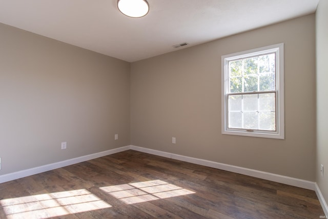 unfurnished room featuring dark hardwood / wood-style flooring