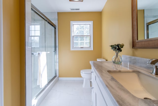 bathroom with a shower with shower door, vanity, and toilet