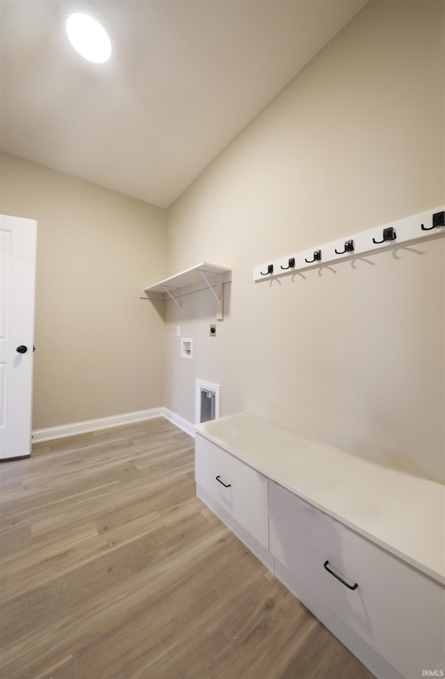 laundry room featuring hookup for a washing machine, hookup for an electric dryer, and light hardwood / wood-style flooring