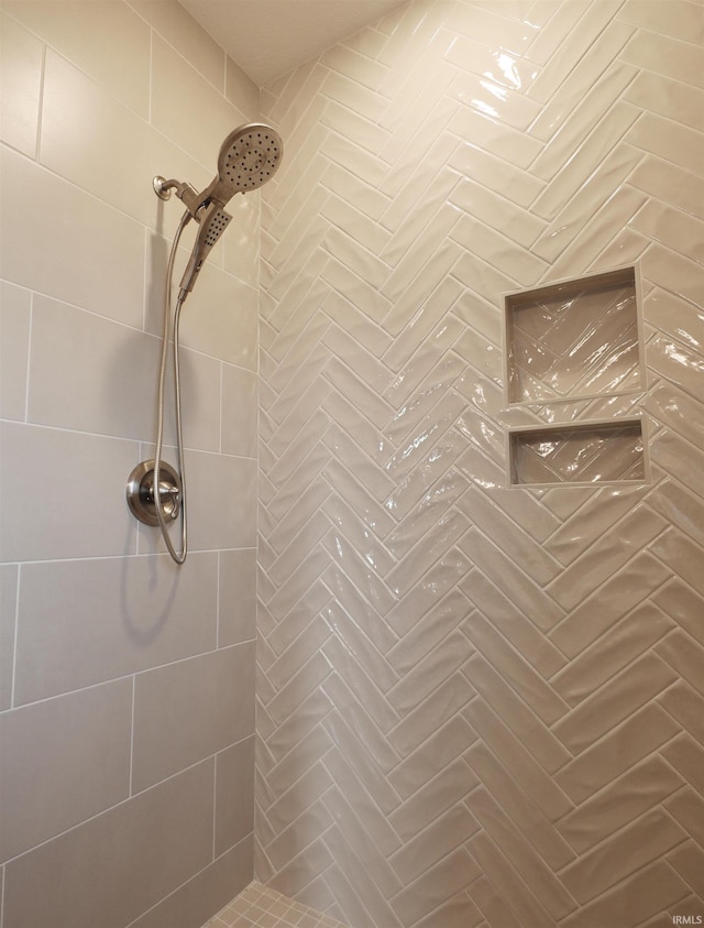 interior details featuring tiled shower