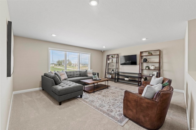 carpeted living room featuring a textured ceiling