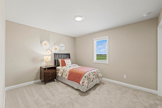 bedroom featuring light carpet