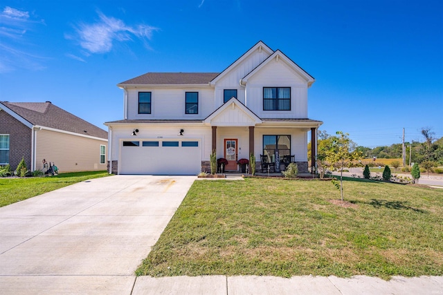 view of front of home featuring a front yard, a porch, and a garage