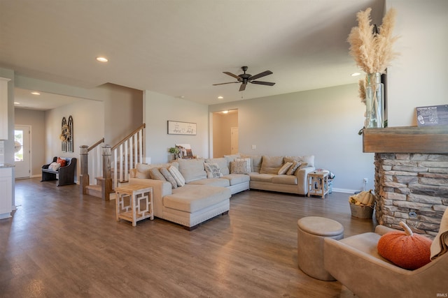 living room with ceiling fan and dark hardwood / wood-style floors