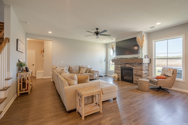 living room with a wealth of natural light, dark hardwood / wood-style floors, and a fireplace