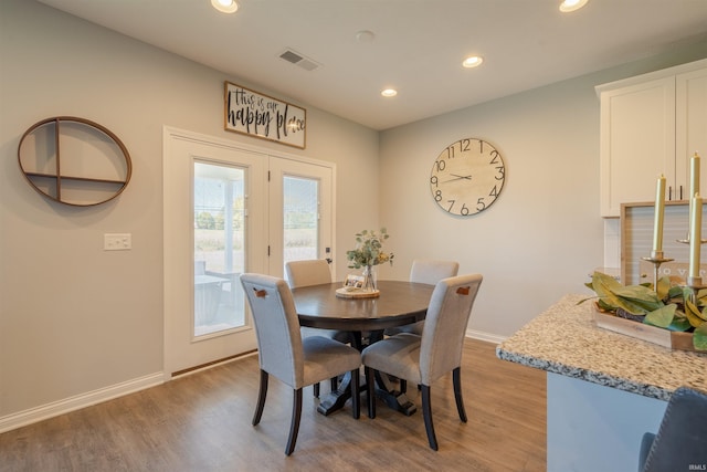 dining area with light hardwood / wood-style floors