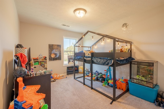 carpeted bedroom featuring a textured ceiling