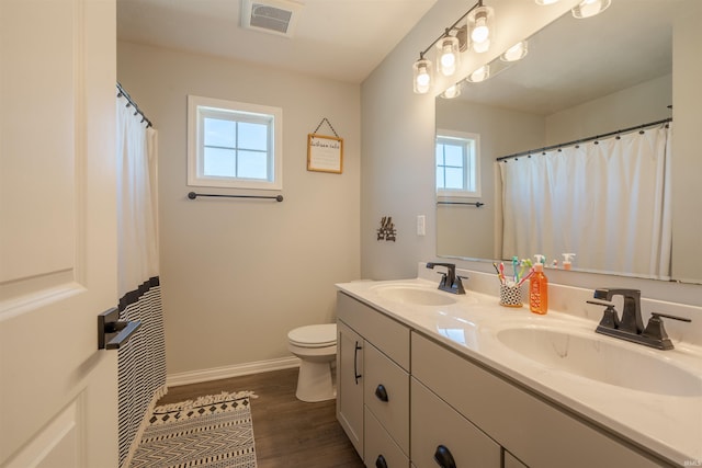 bathroom featuring vanity, hardwood / wood-style floors, and toilet