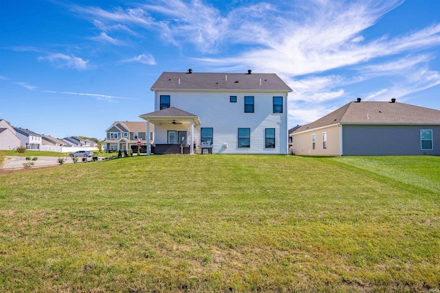 rear view of house with a lawn