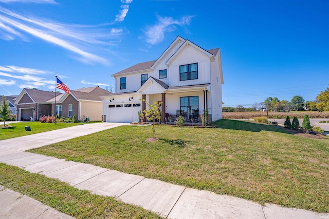 view of front of home with a front yard and a garage