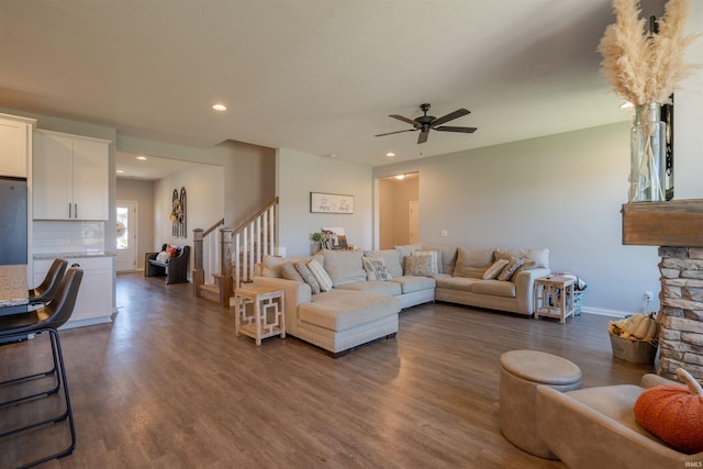 living room with ceiling fan and dark hardwood / wood-style floors