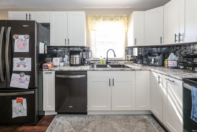 kitchen with light stone counters, sink, white cabinetry, appliances with stainless steel finishes, and decorative backsplash