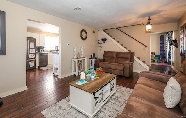 living room with sink and dark wood-type flooring