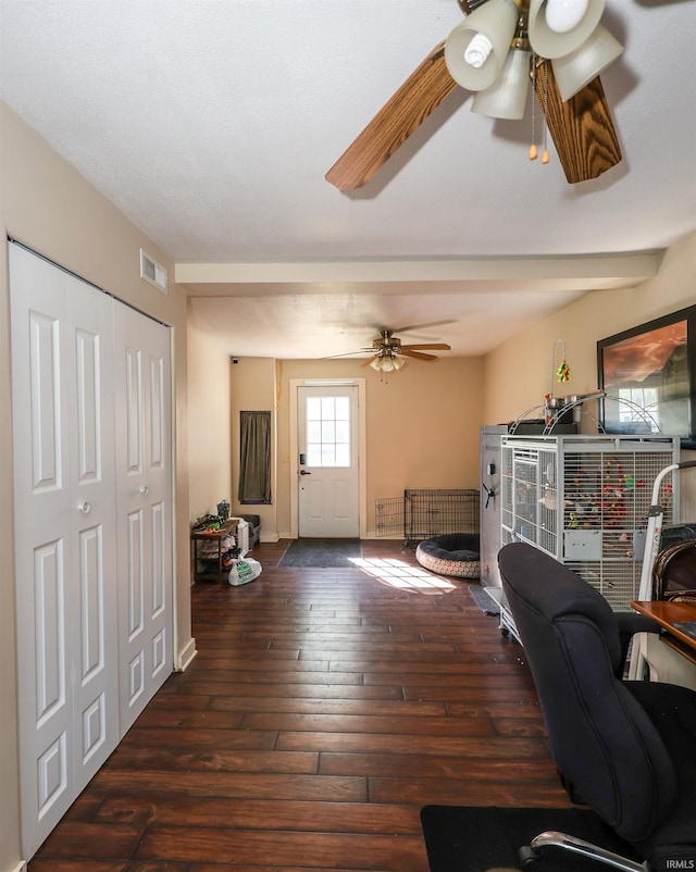 home office featuring dark hardwood / wood-style floors and ceiling fan