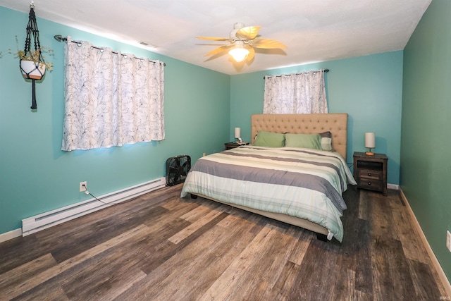 bedroom with a baseboard heating unit, wood-type flooring, and ceiling fan