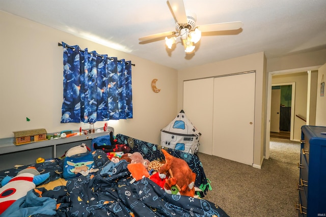 carpeted bedroom featuring ceiling fan and a closet