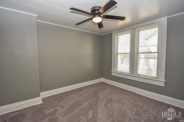 unfurnished room with ornamental molding, carpet, and ceiling fan