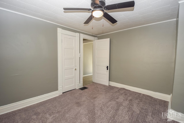 unfurnished bedroom with ceiling fan, ornamental molding, and carpet flooring