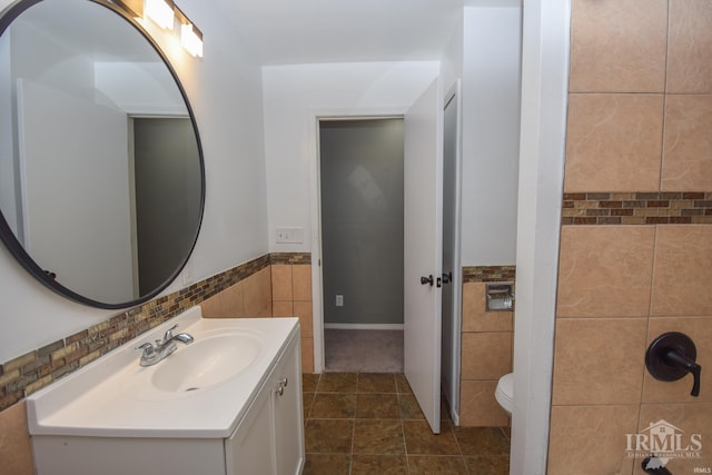 bathroom featuring tile walls, tile patterned floors, vanity, and toilet