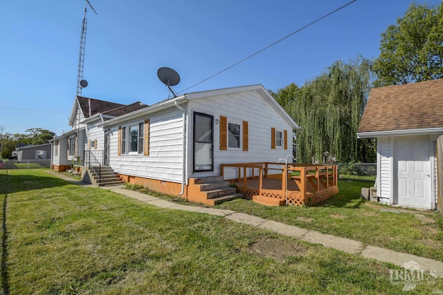 view of front of home with a deck and a front lawn