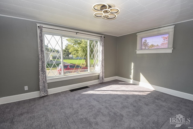 carpeted empty room featuring ornamental molding