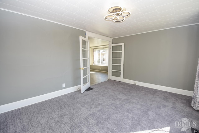 unfurnished room featuring carpet flooring, ornamental molding, and french doors