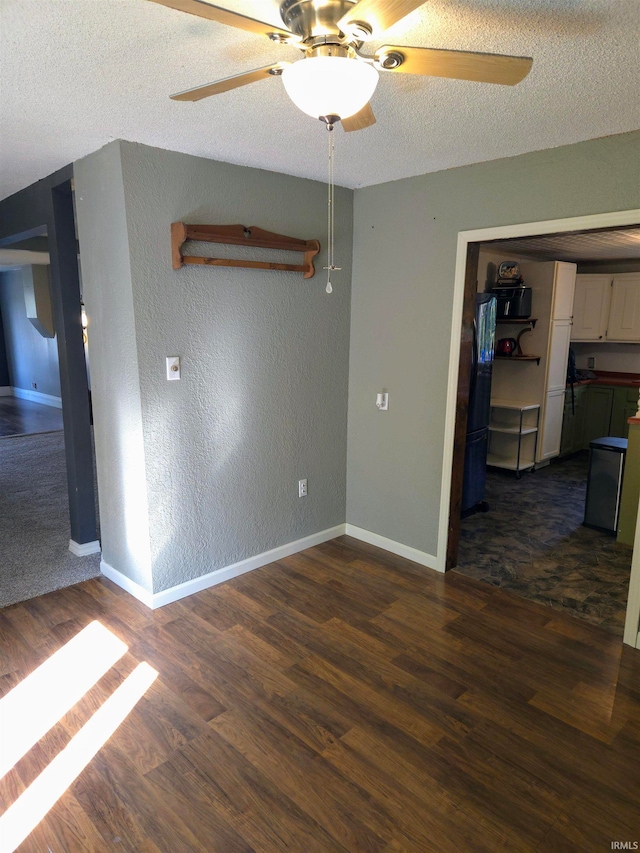 spare room featuring ceiling fan, a textured ceiling, and dark hardwood / wood-style flooring